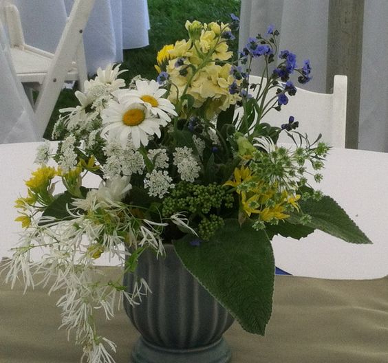 Vase with yellow, white and blue flowers